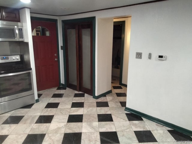 kitchen with appliances with stainless steel finishes and baseboards