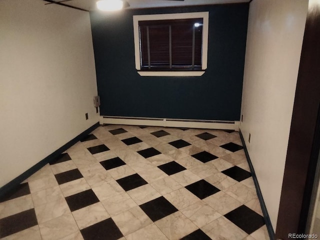 empty room featuring baseboards and a baseboard radiator