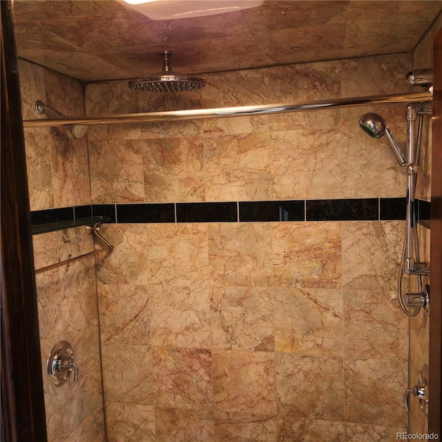 interior details featuring a tile shower