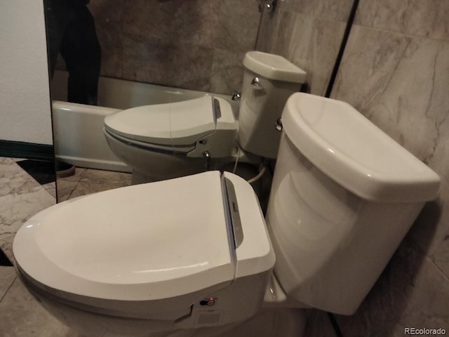 bathroom with toilet and walk in shower