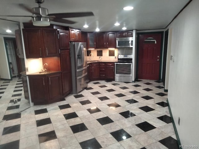 kitchen with a sink, a ceiling fan, recessed lighting, and stainless steel appliances