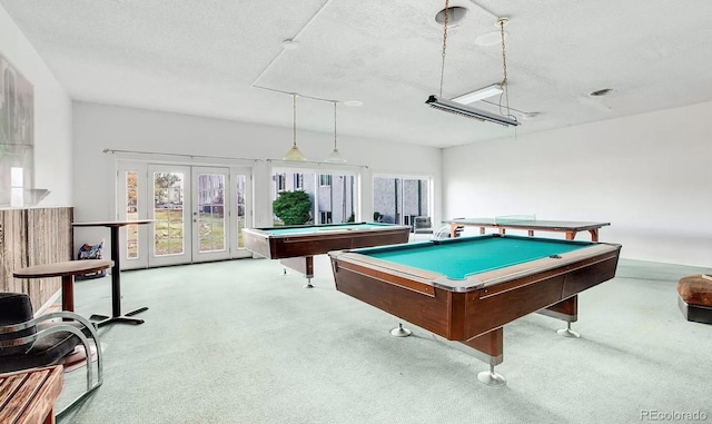 game room featuring a healthy amount of sunlight, french doors, a textured ceiling, and carpet floors