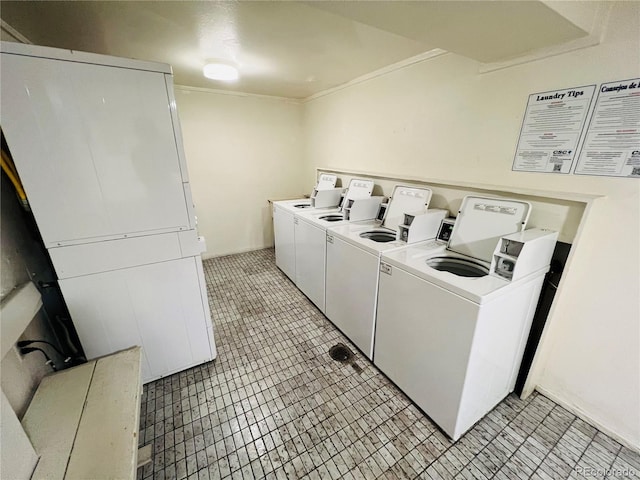 shared laundry area with independent washer and dryer and ornamental molding