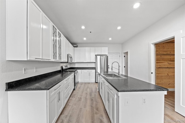 7700 E 29th Ave Unit 102, Denver, CO 80238 - kitchen featuring appliances with stainless steel finishes, a sink, recessed lighting, white cabinets, and light wood finished floors