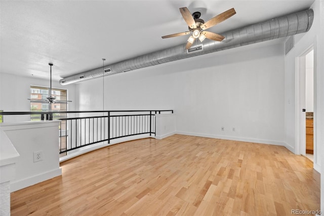 7700 E 29th Ave Unit 102, Denver, CO 80238 - spare room with a ceiling fan, light wood-type flooring, and baseboards
