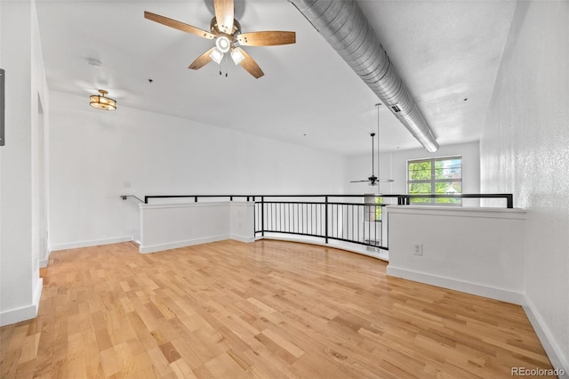 7700 E 29th Ave Unit 102, Denver, CO 80238 - empty room with ceiling fan, light wood-style flooring, and baseboards
