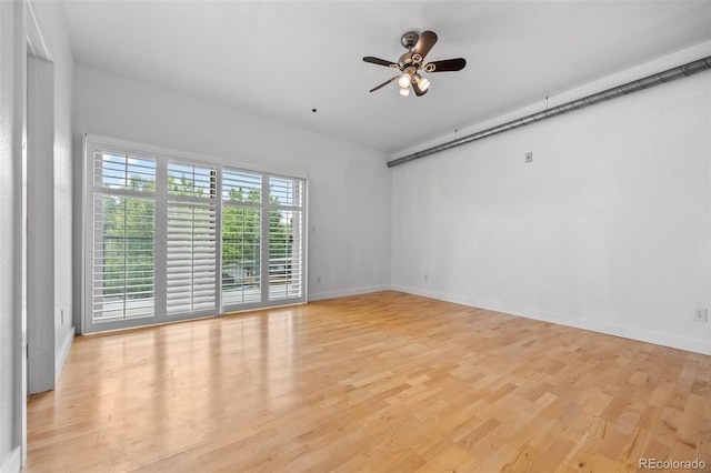 7700 E 29th Ave Unit 102, Denver, CO 80238 - empty room featuring light wood-style flooring, a ceiling fan, and baseboards
