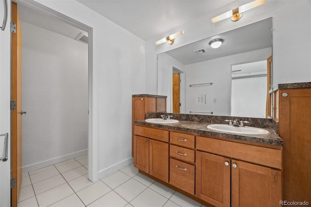 7700 E 29th Ave Unit 102, Denver, CO 80238 - full bathroom with double vanity, tile patterned flooring, and baseboards