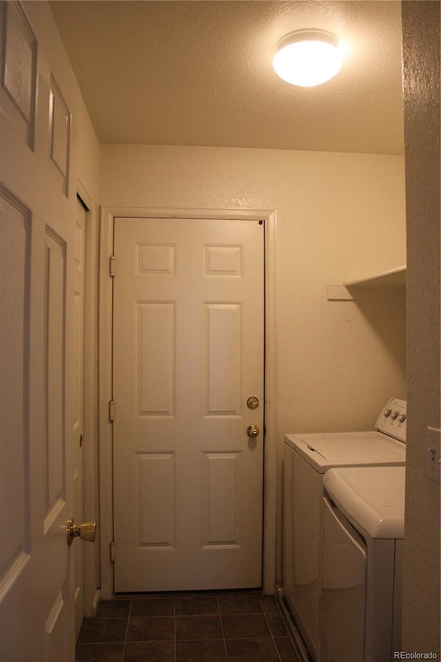213 Mesa St, Brighton, CO 80601 - washroom featuring separate washer and dryer and dark tile patterned floors