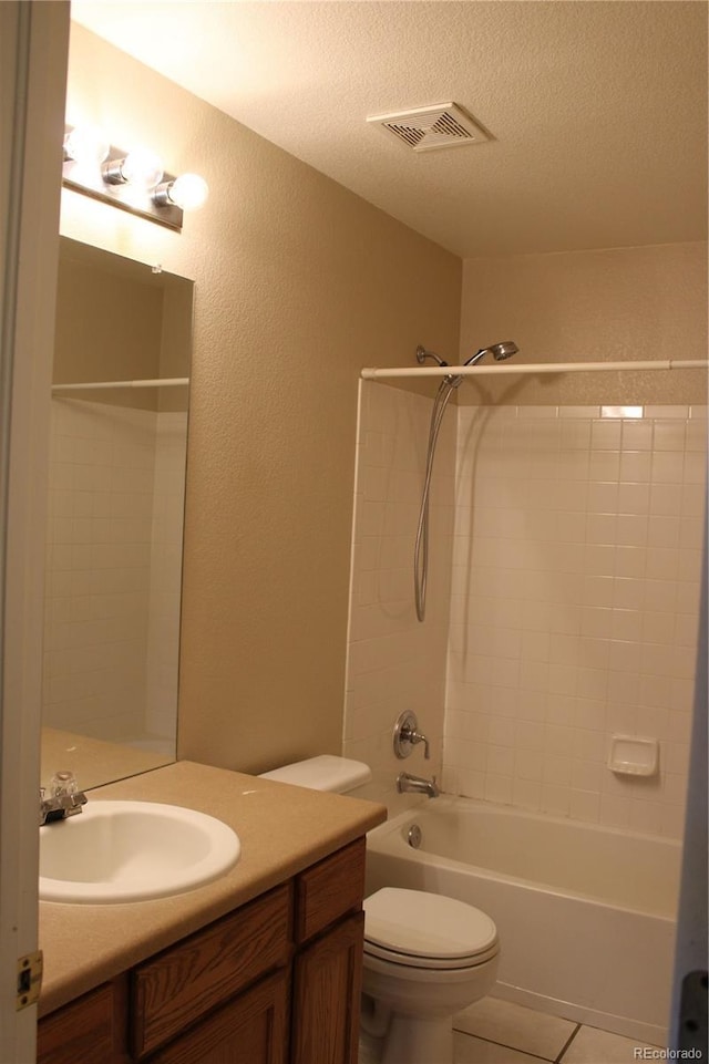 213 Mesa St, Brighton, CO 80601 - full bathroom featuring vanity, shower / bath combination, toilet, tile patterned flooring, and a textured ceiling