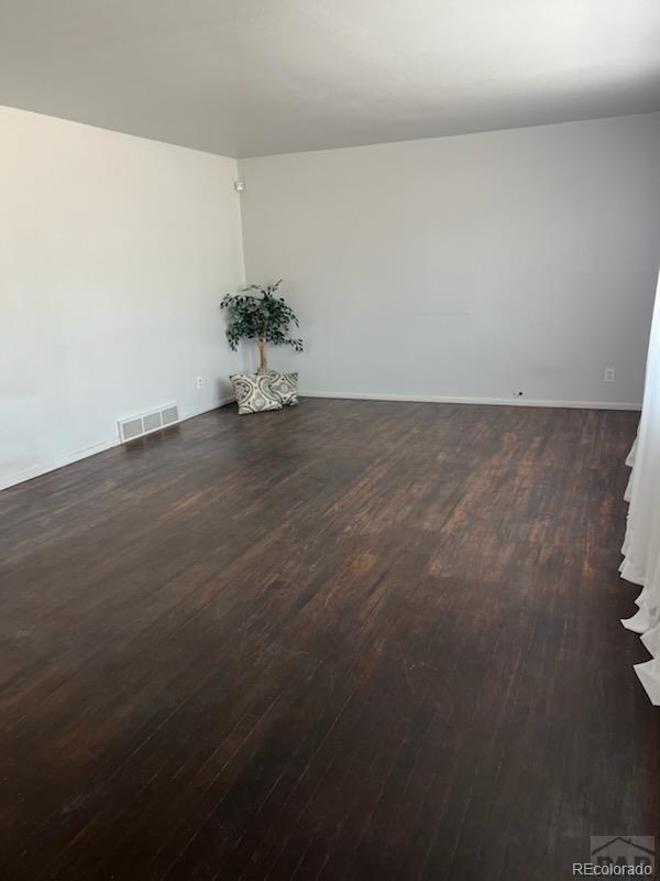 unfurnished room featuring dark hardwood / wood-style floors