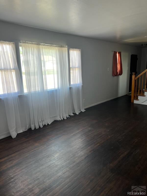 empty room with dark wood-type flooring