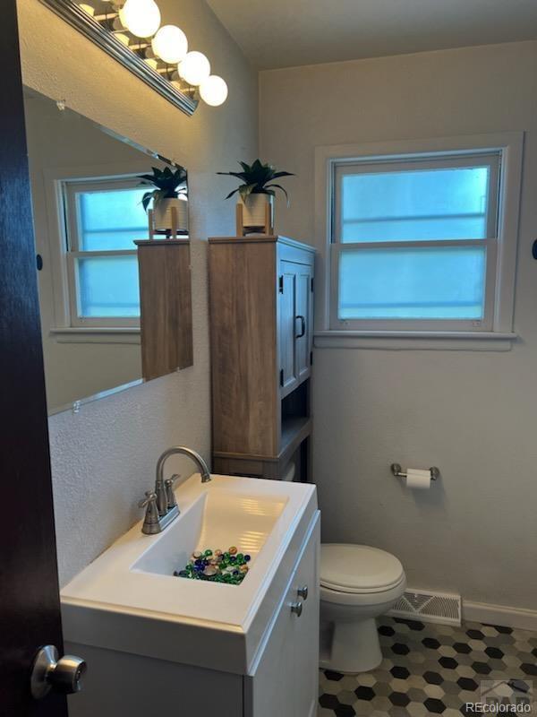 bathroom featuring toilet and vanity