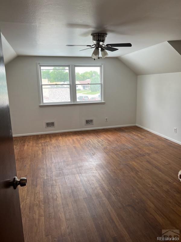 spare room featuring vaulted ceiling, dark hardwood / wood-style flooring, and ceiling fan