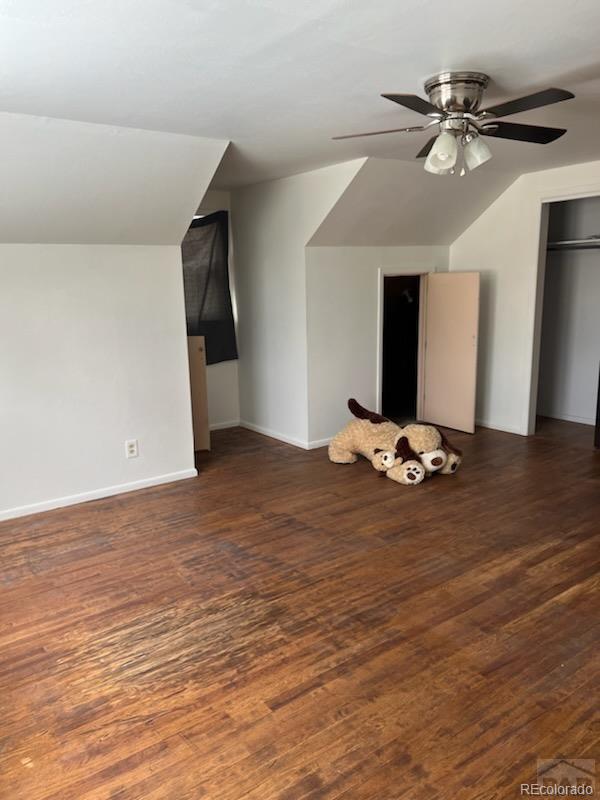 bonus room with lofted ceiling, ceiling fan, and dark hardwood / wood-style floors