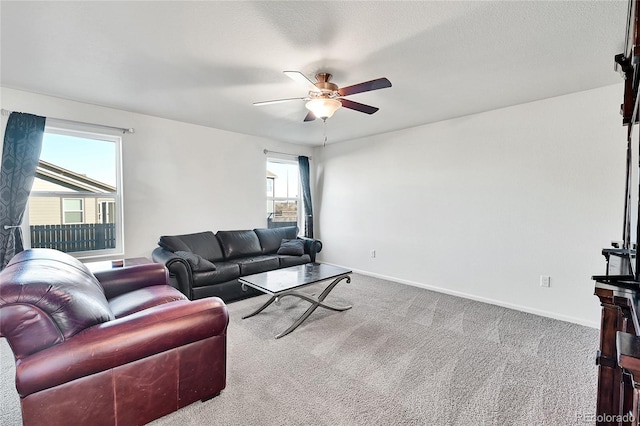 living room with carpet, ceiling fan, and a textured ceiling