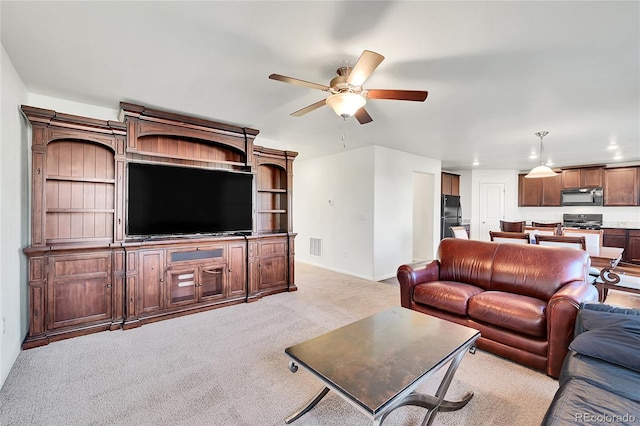 living room with light carpet and ceiling fan