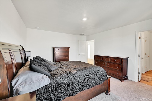 bedroom with light colored carpet