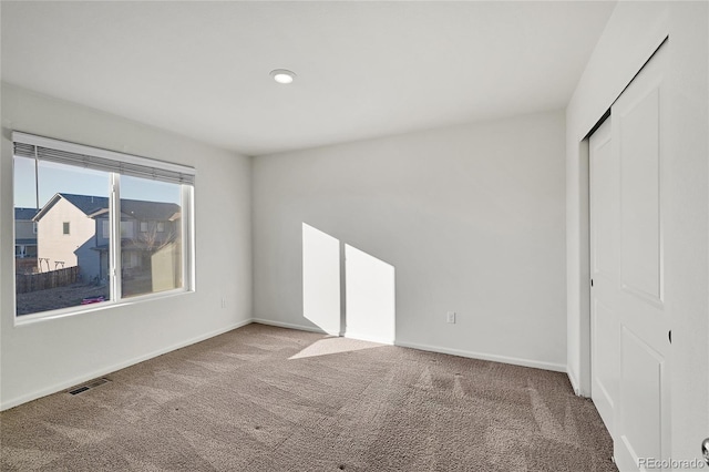 unfurnished bedroom with carpet floors and a closet