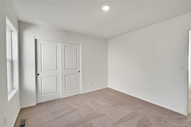 unfurnished bedroom featuring a closet and carpet