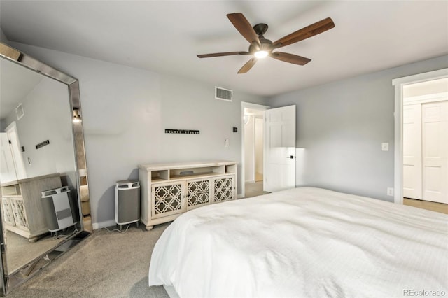 bedroom featuring heating unit, ceiling fan, and carpet