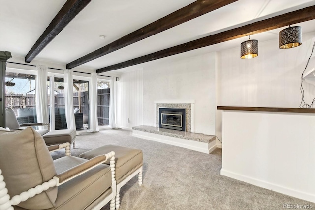 living room with beam ceiling, light carpet, and a high end fireplace