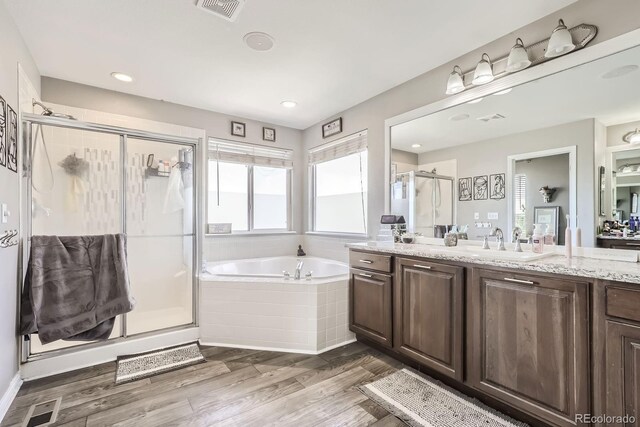 10811 Chambers Way, Commerce City, CO 80022 - bathroom featuring a garden tub, plenty of natural light, a shower stall, vanity, and recessed lighting