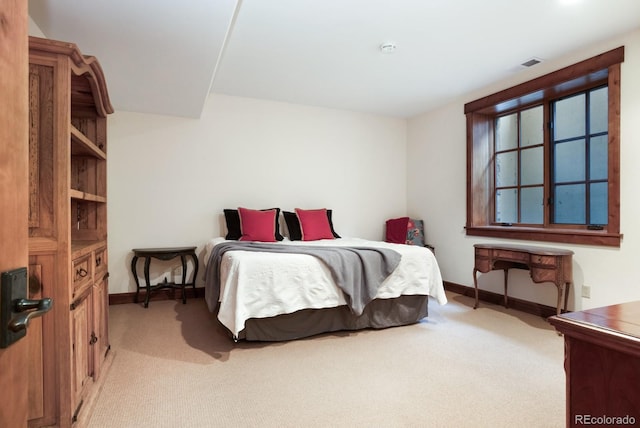 bedroom featuring baseboards, light colored carpet, and visible vents