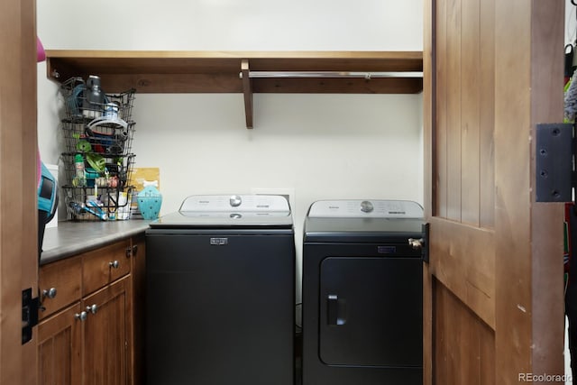 laundry room with cabinet space and washer and clothes dryer