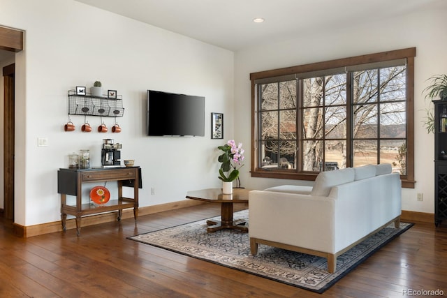 living area with baseboards, recessed lighting, and hardwood / wood-style flooring