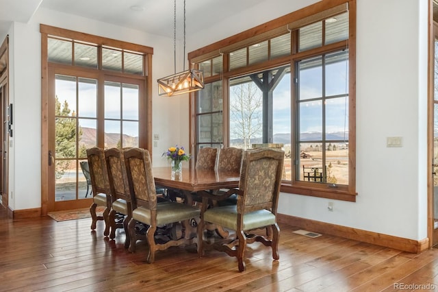 dining room featuring a wealth of natural light, visible vents, and wood-type flooring