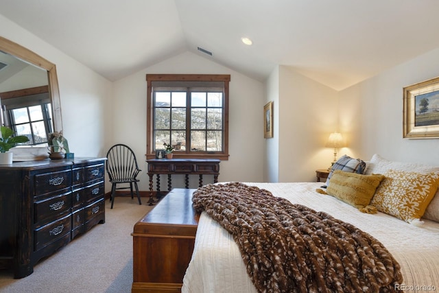 bedroom with carpet flooring, lofted ceiling, and visible vents