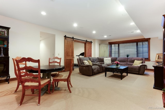 living room with light colored carpet, a barn door, baseboards, and recessed lighting