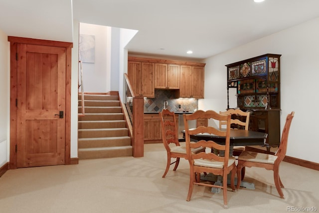 dining space with light carpet, baseboards, stairs, and recessed lighting