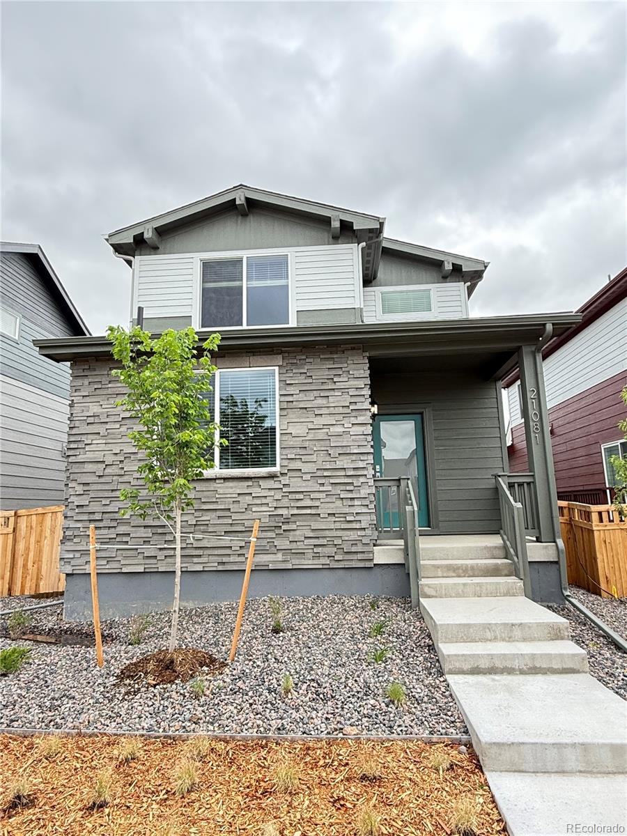 21081 E 63rd Dr, Aurora, CO 80019 - view of front of house featuring stone siding and a porch
