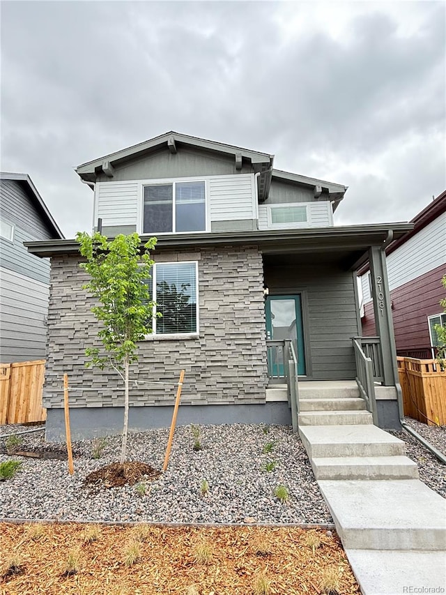 21081 E 63rd Dr, Aurora, CO 80019 - view of front of house featuring stone siding and a porch