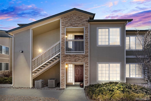 view of front of home with a balcony and cooling unit