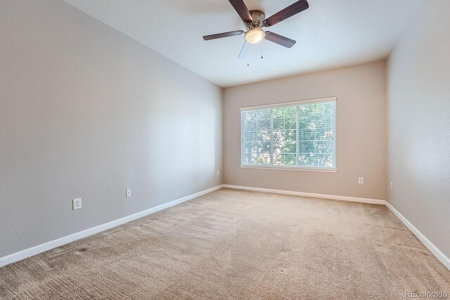 carpeted empty room featuring ceiling fan