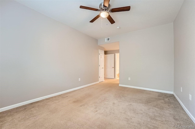 carpeted spare room featuring ceiling fan