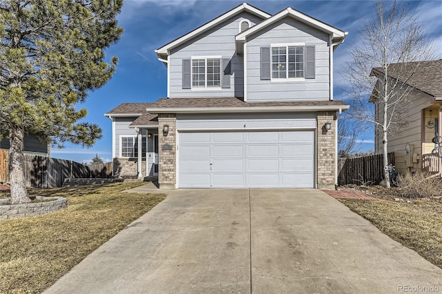 traditional home with a garage, brick siding, fence, and driveway