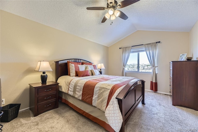 bedroom featuring light colored carpet, vaulted ceiling, and a textured ceiling