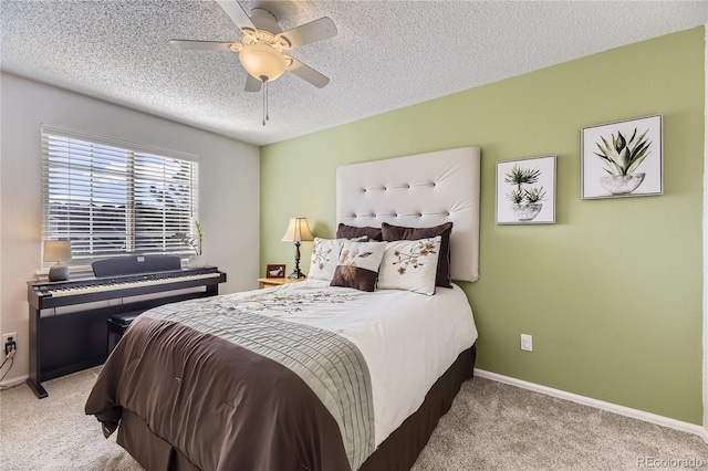 bedroom with a ceiling fan, a textured ceiling, baseboards, and carpet flooring