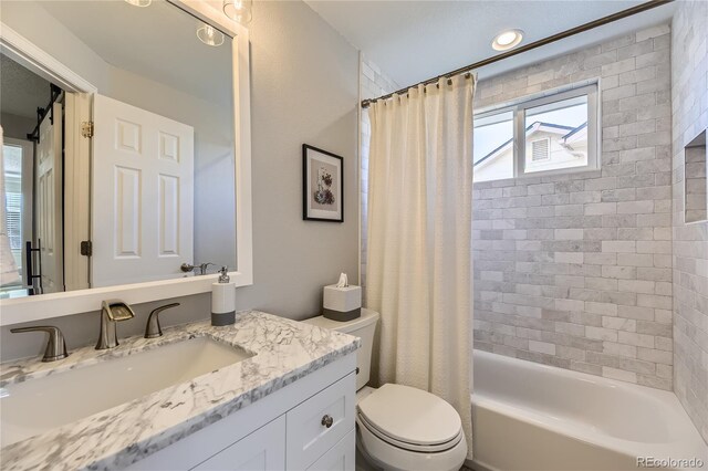 full bath with toilet, shower / tub combo with curtain, and vanity