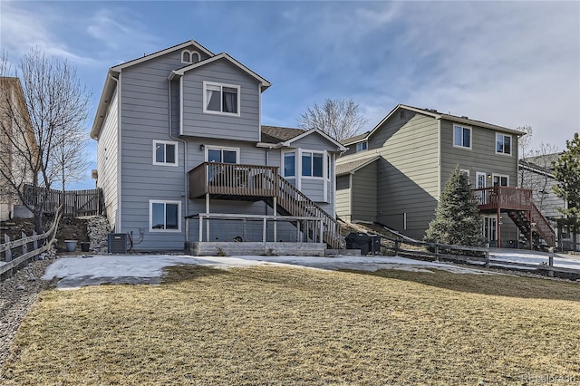 rear view of property featuring central air condition unit, stairs, fence, and a yard