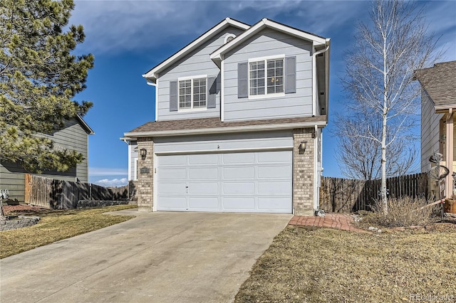 traditional-style home with a shingled roof, concrete driveway, an attached garage, fence, and brick siding