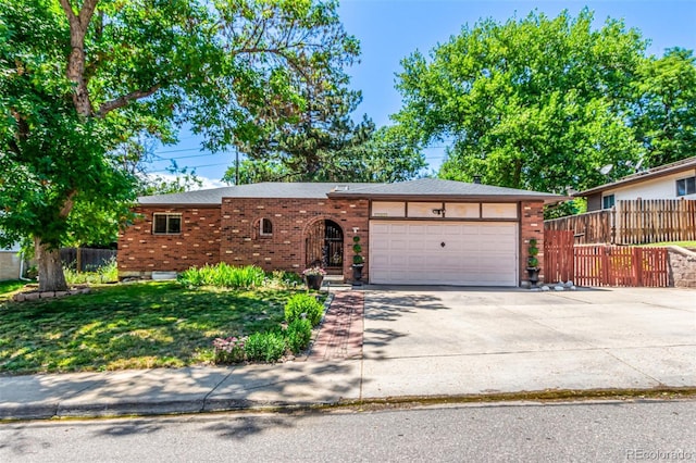 9861 Pecos St, Thornton, CO 80260 - view of front facade with a garage, concrete driveway, and brick siding