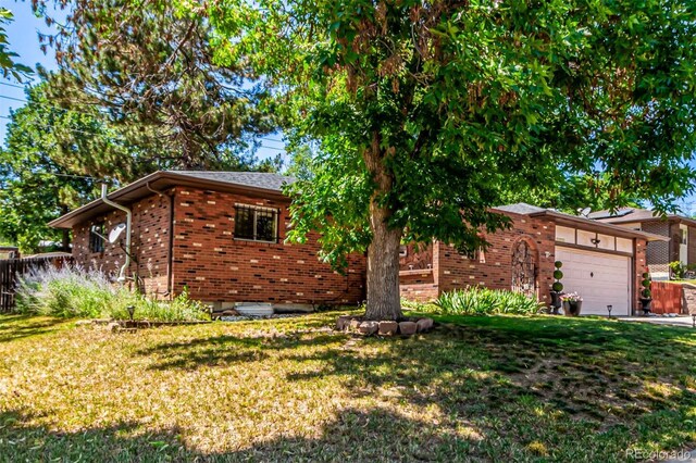 9861 Pecos St, Thornton, CO 80260 - view of front of house with brick siding and a front lawn