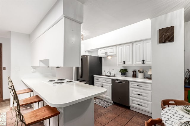 9861 Pecos St, Thornton, CO 80260 - kitchen with stainless steel appliances, a kitchen bar, a peninsula, light countertops, and white cabinetry