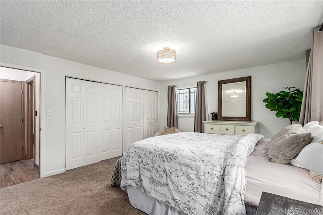 9861 Pecos St, Thornton, CO 80260 - carpeted bedroom with multiple closets and a textured ceiling