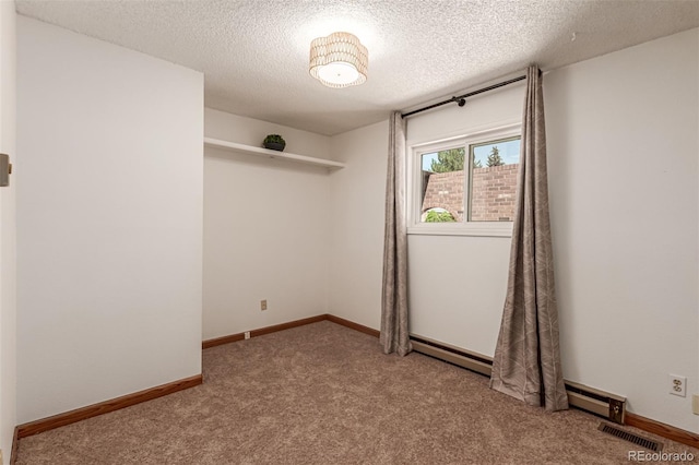 9861 Pecos St, Thornton, CO 80260 - carpeted empty room with baseboard heating and a textured ceiling